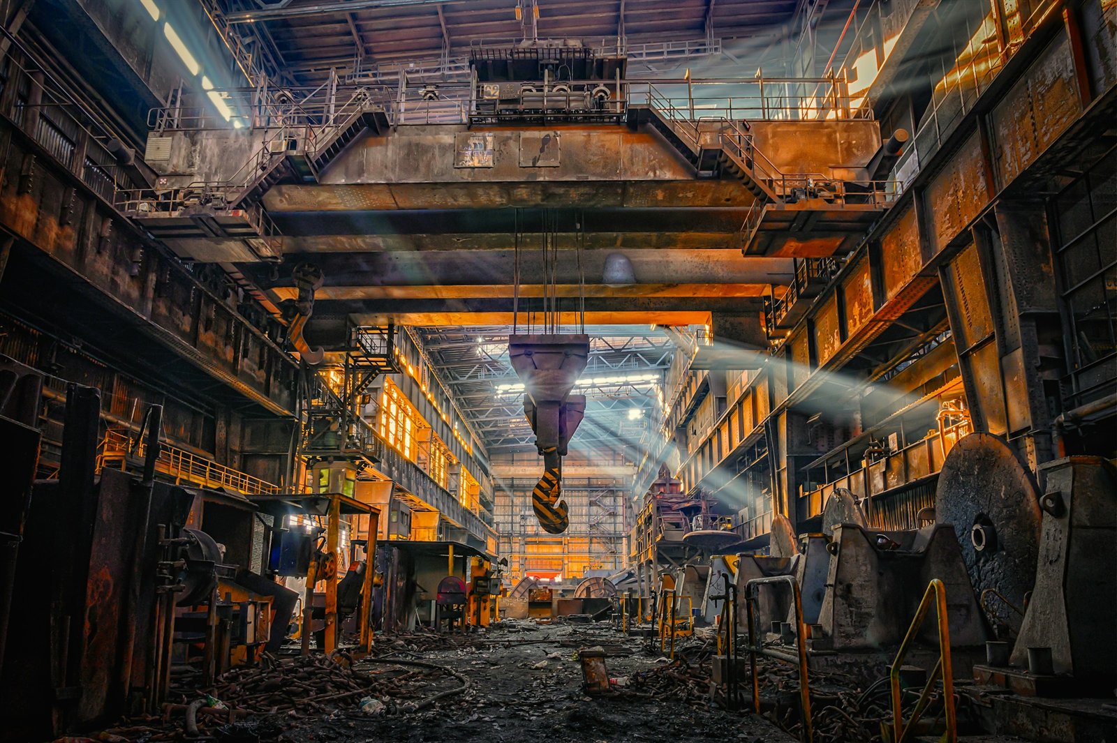 Heavy overhead crane machinery inside an industrial steel mill, representing the kind of single-site manufacturing facility a supply chain can end up depending on