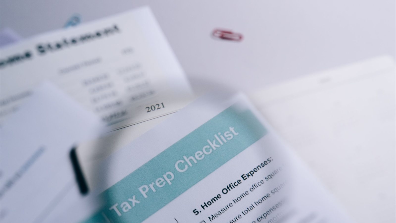 A checklist and financial statement under review, representing the paper trail an internal audit works through